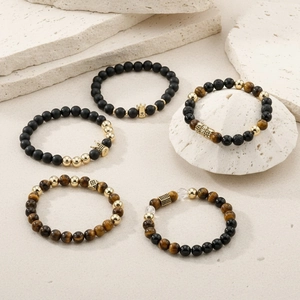 Five-piece black matte bead and tiger eye crown charm bracelets with gold accents