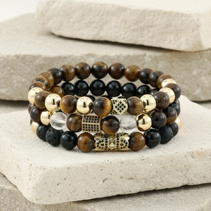 Detail of beaded bracelet set with tiger eye, matte lava stones and gold metal accents