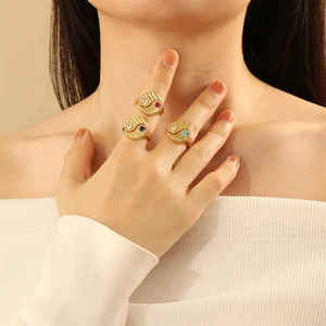 Three gold Yin Yang rings with colorful zircon inlays worn on a model's hand