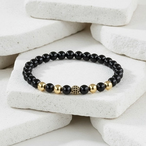 Detailed shot of black beaded crown bracelet with pavé zircon ball on stone plates