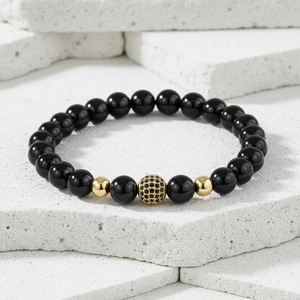 Detail of beaded bracelet with black onyx beads and golden micro-pave zircon sphere