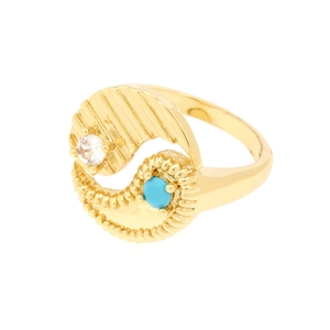 Detail of gold-plated yin-yang ring with blue stone and sparkling zircon inlay