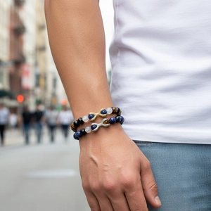 Detail of beaded bracelets with lapis lazuli and infinity charm on a model wrist