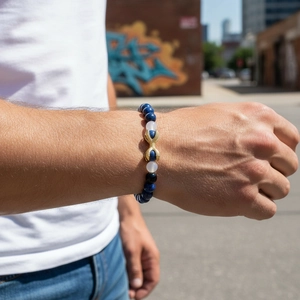 Detail of blue lapis lazuli and white beads bracelet on male model wrist in urban style