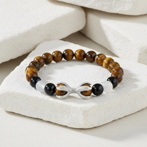 Detailed shot of beaded bracelet with tiger eye stones and a silver eagle claw charm