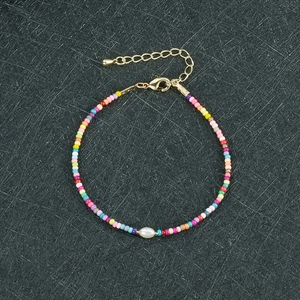 Dettaglio del bracciale di perline colorate con perla singola e chiusura a moschettone oro