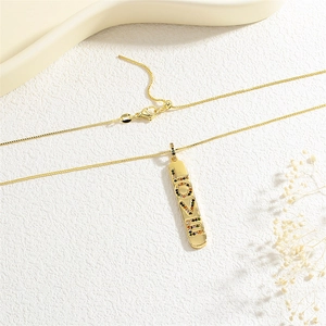 Close-up of golden vertical pendant with LOVE lettering and colorful micro-set zircons