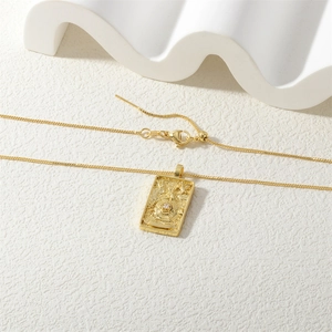 Detail of gold Solomon Tarot pendant with embossed textures and adjustable box chain