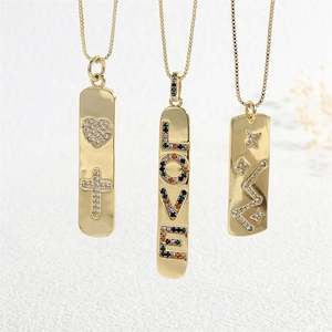 Detail of gold necklaces with cubic zirconia inlays, LOVE letters, and star patterns