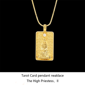 Macro detail of The High Priestess tarot card pendant with a white zircon and gold finish