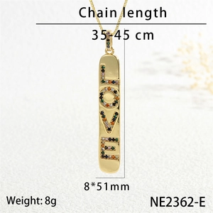 Detailed macro view of gold vertical bar pendant with colorful LOVE crystal inlay and fine chain