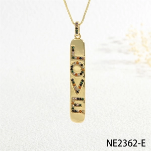 Detail view of gold bar pendant with LOVE letters and colorful pavé cubic zirconia