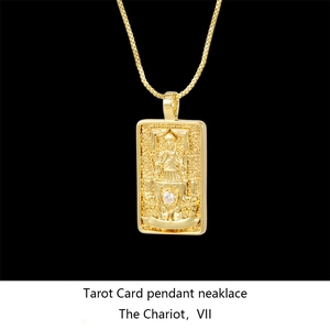Macro shot of gold-plated Chariot tarot card pendant with diamond accent on box chain
