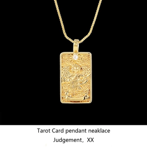 Macro shot of gold tarot pendant Judgement with sparkling cubic zirconia on black base