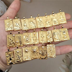 Golden Nordic Solomon Tarot necklaces with square pendants and crystals held in hand