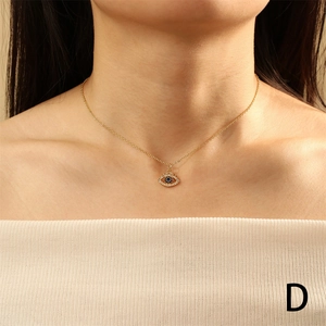 Golden Evil Eye pendant necklace with blue center stone and diamonds on a model