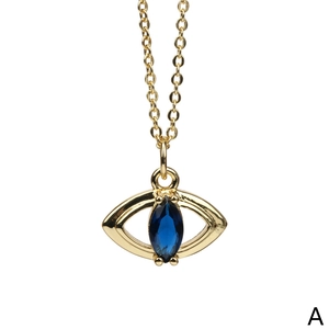 Macro detail of gold plated Evil Eye pendant featuring a blue marquise cut zircon stone