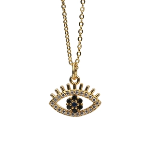 Detailed close-up of Evil Eye pendant with blue zircons on a gold-plated necklace chain