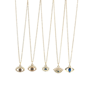 Detailed close-up of five different evil eye crystal pendant necklaces in gold finish