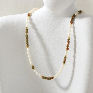 Detail of freshwater pearls and faceted unakite stone necklace on a white bust stand