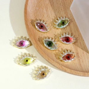 Macro shot of colorful crystal evil eye pendants with micro-pave gold plated settings