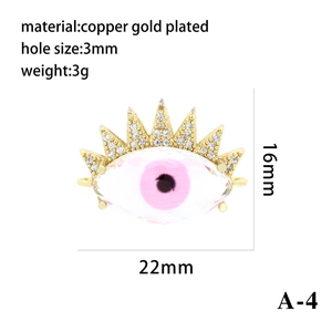 Macro view of gold plated evil eye pendant showing detailed pink crystal and pavé zircon