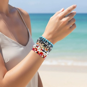 Close-up of bohemian colorful Tila bead bracelets with a detailed evil eye charm