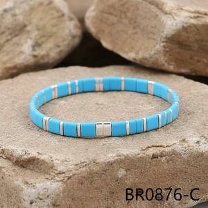 Detail of sky blue Tila beads bracelet with silver spacers on natural rock surface