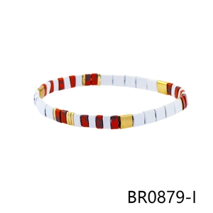 Detailed view of colorful enamel square beads and gold accents on bohemian bracelet