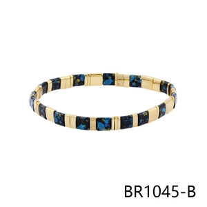Detail of bohemian stretch bracelet with 18K gold metal beads and blue yellow enamel tiles