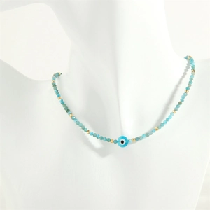 Detailed close-up of handmade glass eye beads with blue faceted stones and gold spacers