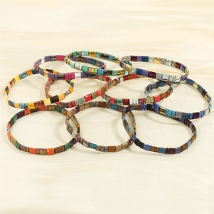 Colorful Bohemian Tila tile bead stretch bracelets on elegant cream silk background