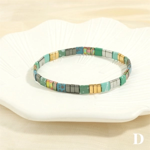 Bohemian TILA bead elastic bracelet with colorful matte cubes inside a shell-shaped dish