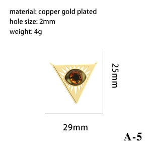Detail view of a 29mm triangle evil eye pendant in copper gold plated finish with 2mm holes