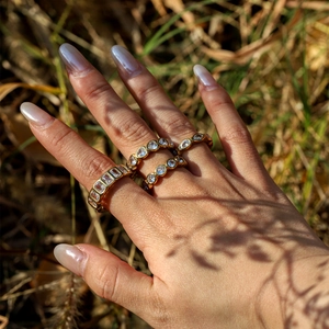 Detailed view of three-piece 18K gold plated stackable rings with cubic zirconia stones
