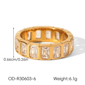 Detail showing 6.6mm gold wide band ring with inlaid baguette cut cubic zirconia