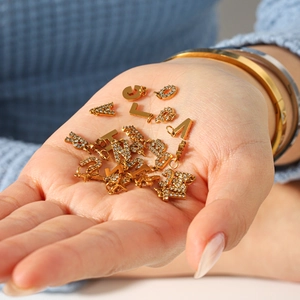 Handheld photo of 18k gold-plated 26-letter pendants with small diamonds for DIY jewelry