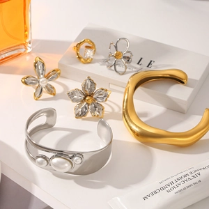 Two-tone gold and silver irregular bangle set with pearl cuff and floral rings