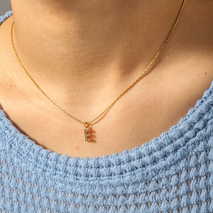 Elegant 18k gold-plated necklace with a crystal-studded letter E pendant on a thin chain