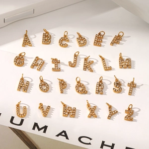 Macro detail of 18k gold plated 26 alphabet pendants with micro-pave cubic zirconia