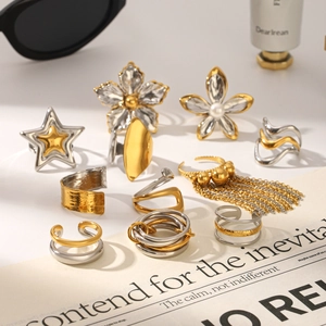 Modern mixed metal rings with star and floral motifs with pearl and tassel accents
