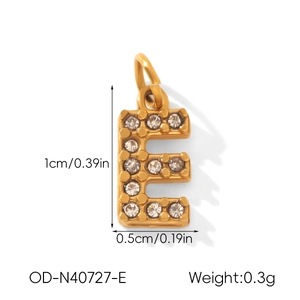 Detailed view of gold letter E pendant with dimensions 1cm by 0.5cm and sparkling crystals