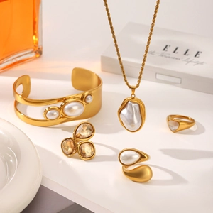 Baroque style gold jewelry set with pearl necklace, bracelet, and heart shaped ring