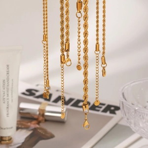 Close-up of golden stainless steel twist rope necklaces with S.Steel engraved tag