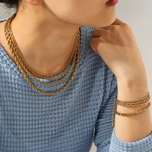 Detail of layered 18K gold plated rope chain necklaces and matching bracelet set
