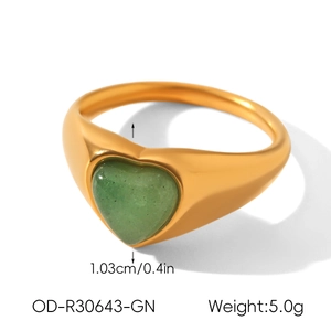 Macro detail of heart-shaped green stone ring with matte gold band measurements and weight