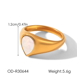 Detail view of gold stainless steel ring with pear-shaped white stone inlay and dimensions