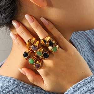 Macro shot of French vintage gold titanium rings with colorful natural stone gemstones