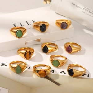 Macro shot of French vintage gold titanium steel rings with assorted natural gemstones