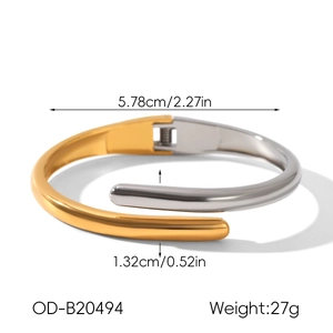 Detail view of two-tone stainless steel bypass bangle with dimensions and hinge specs